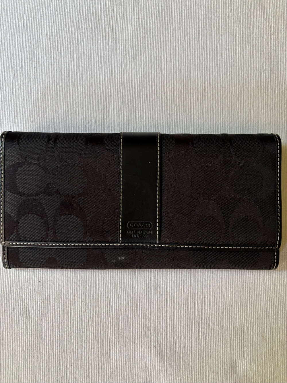 Coach Black Signature Bi-Fold Wallet with integrated zipper pocket for coins.